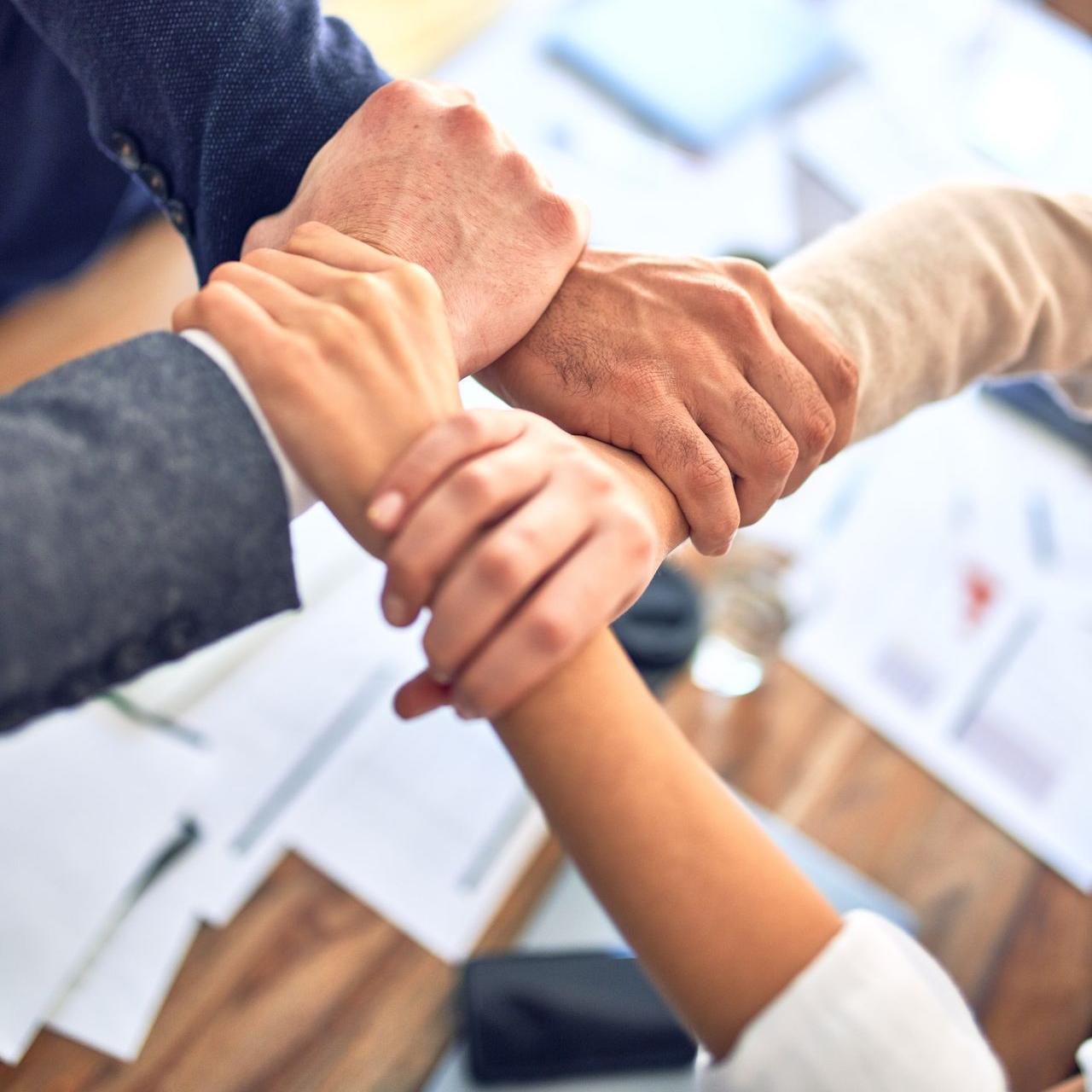 person in black long sleeve shirt holding persons hand